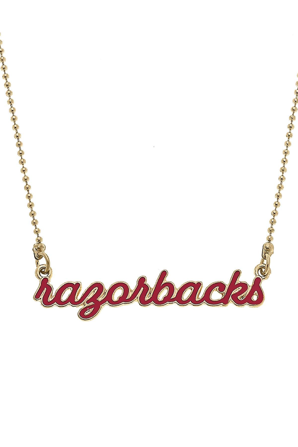 close-up of necklace with red "razorback" bar.