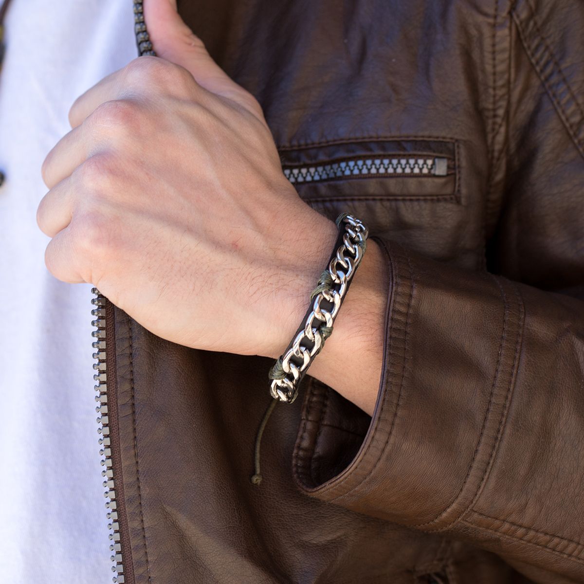 black leather band with chain bracelet on a person's wrist.