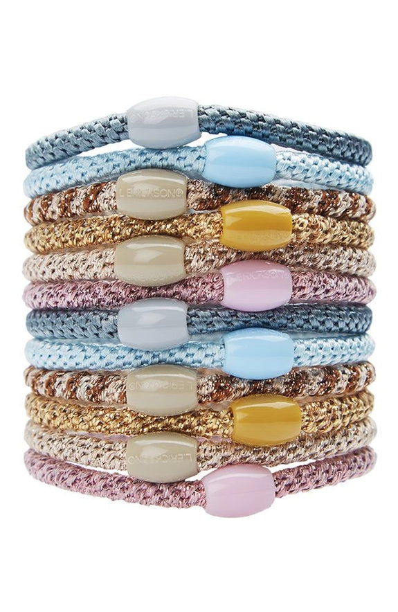 ballerina stack of 12 ponytail holders each with coordinating oval bead on a white background.