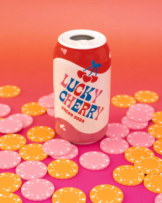 lucky cherry vase on a pink surface surrounded by pink and yellow poker chips.