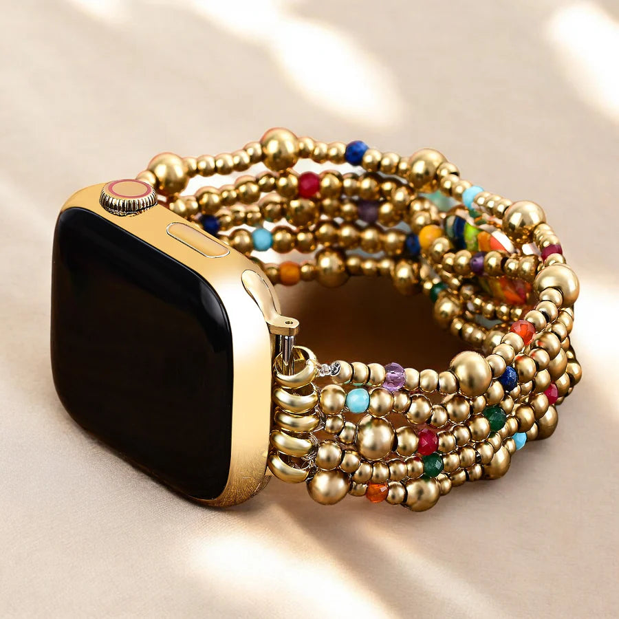 Smartwatch with gold and colorful beaded strap on a beige background