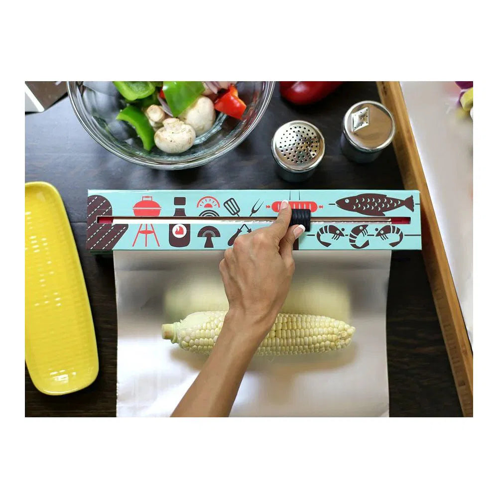 hand using cutter on BBQ tools Aluminum Foil Dispenser