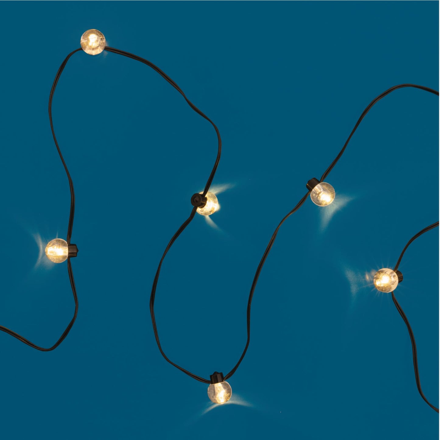 lit string of lit mini lights shown on a blue background.