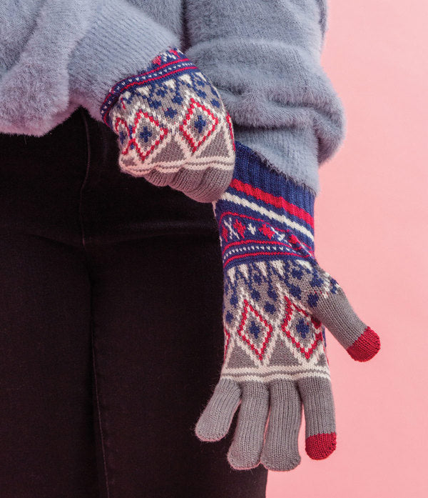 a child pulling the Kid's Fair Isle Gloves on