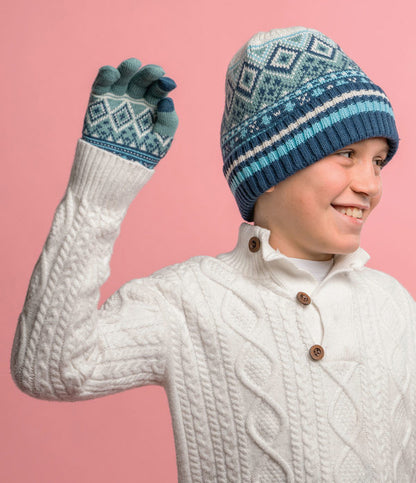 a child wearing the navy Kid's Fair Isle Beanie against a pink background