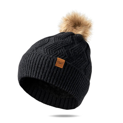 black  Mainstay Pom Hat with faux fur pom displayed against a white background