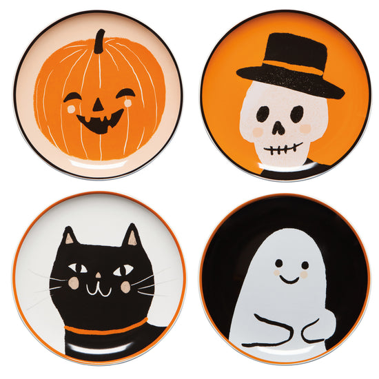 four Halloween-themed plates with a pumpkin, skull, cat, or ghost design