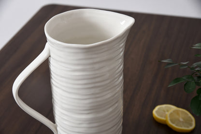 white ceramic pitcher on a table