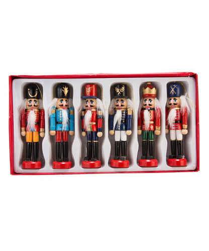 all six wooden nutcracker ornaments displayed in the box against a white background