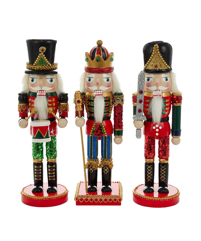 one king, one drummer, and one sward nutcrackers with glitter pants displayed against a white background