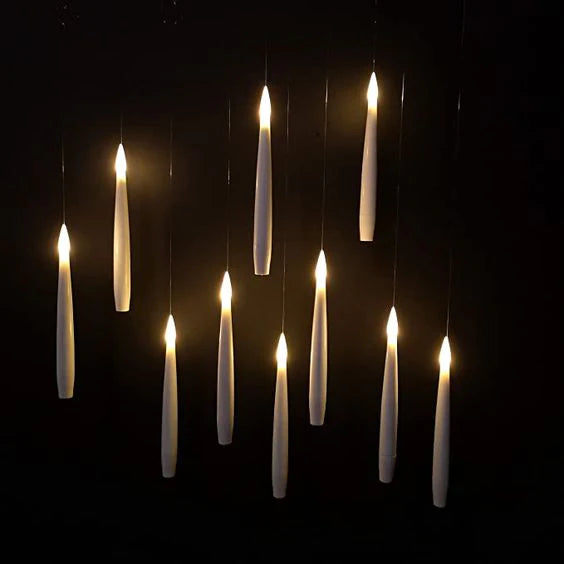 Set of hanging candles against a dark background