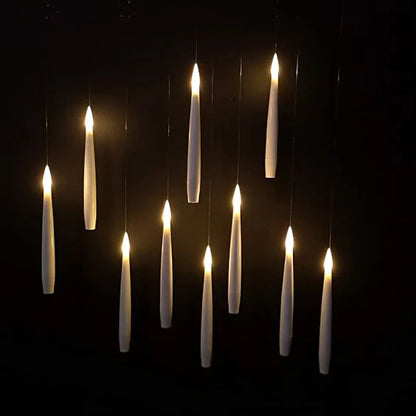Set of hanging candles against a dark background