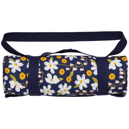 picnic blanket rolled up and secured with carrying strap