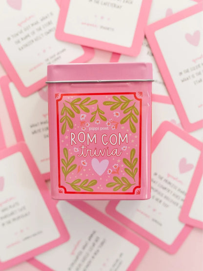 rom com trivia tin laying on scattered cards