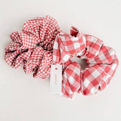 2 red gingham scrunchies on a taupe background