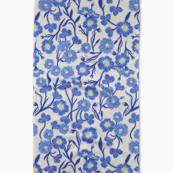 off white towel with blue primavera flowers on it