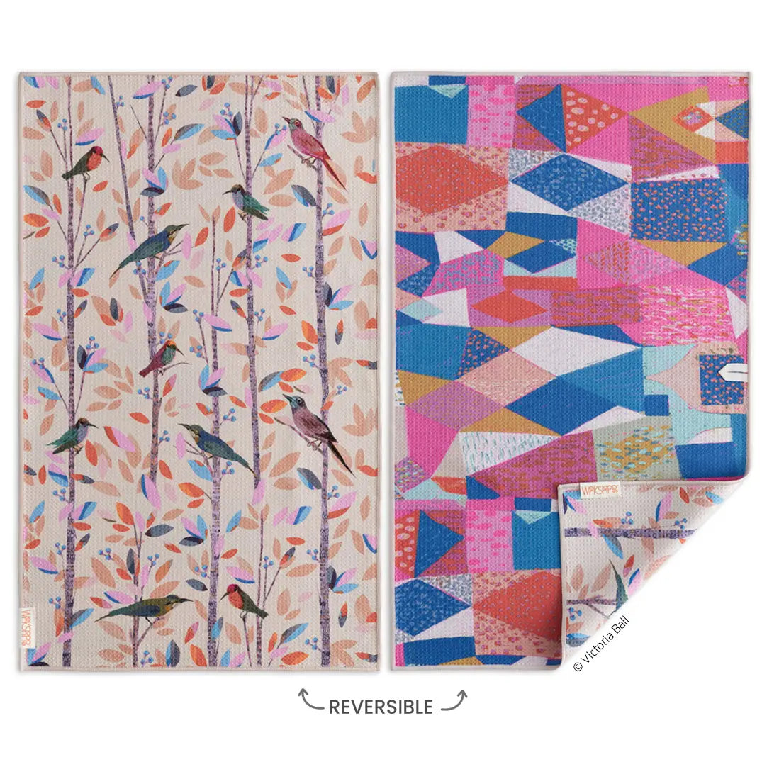 reversible towel with vibrant birds on one side and a geometric pattern on the other