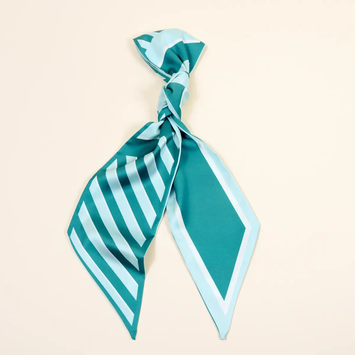Teal and light blue striped scarf on a beige background