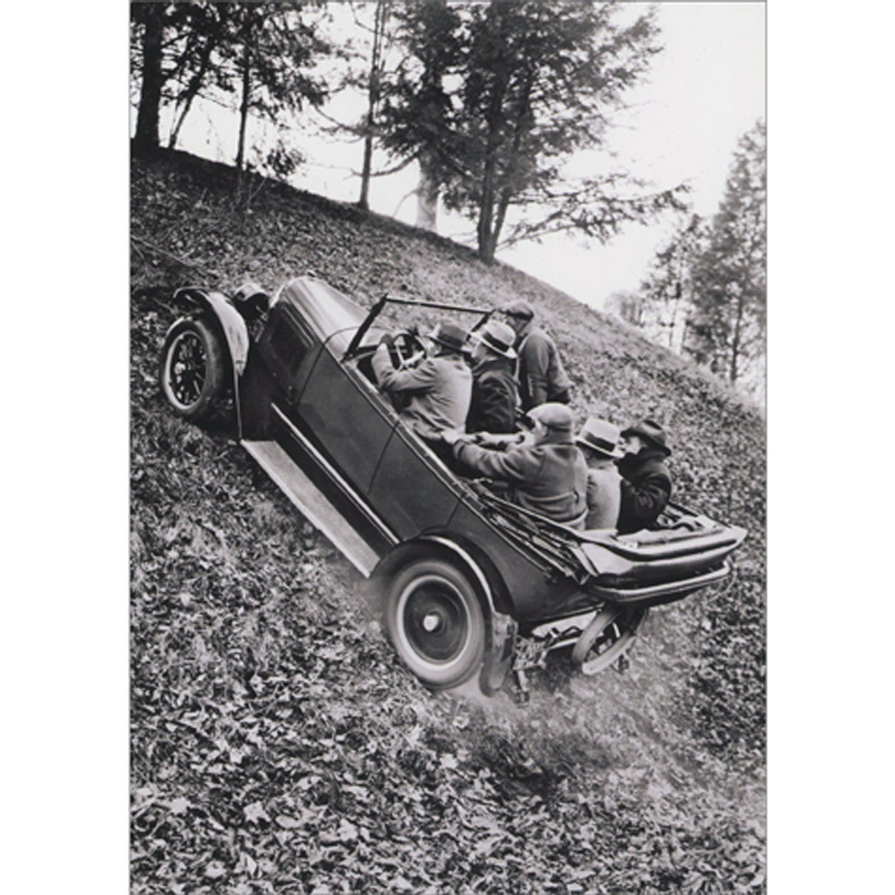 front of card is six men inside an old-timey car driving up a hill