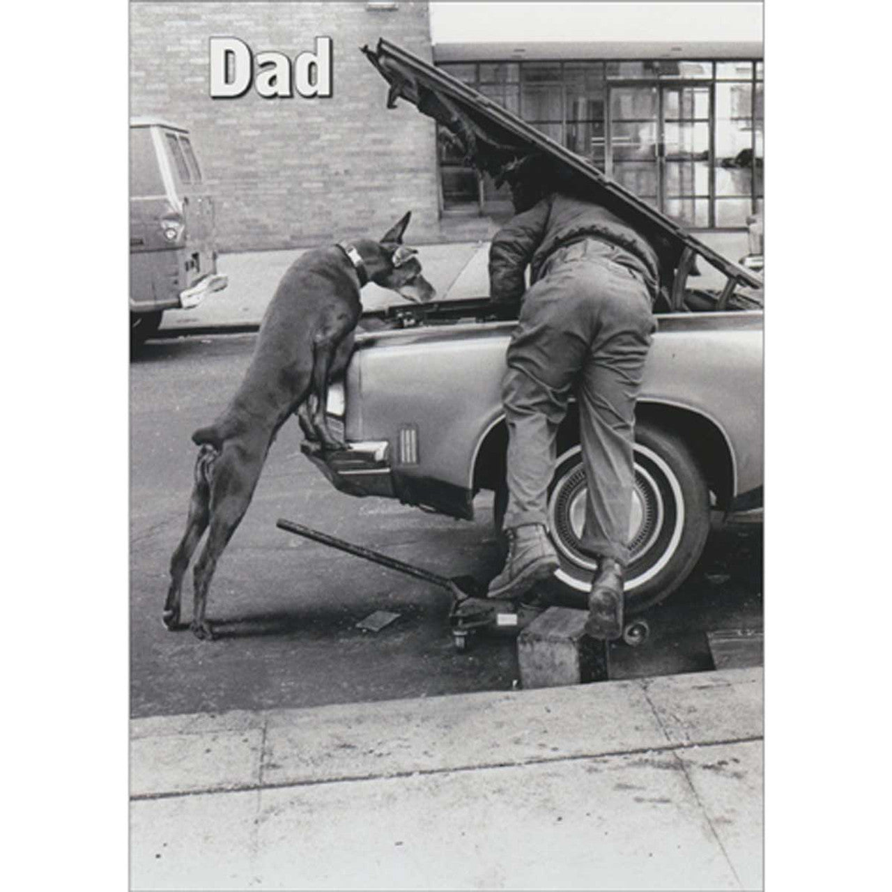 front of card with black and white image of man and dog leaning under an open car hood