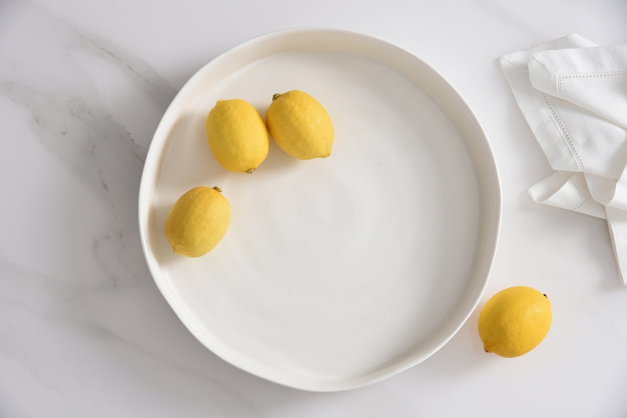 top down view of the le blanc round platter with lemons in it