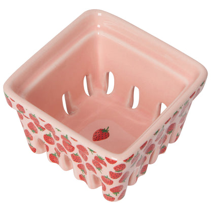 pink ceramic berry basket with red strawberries in center