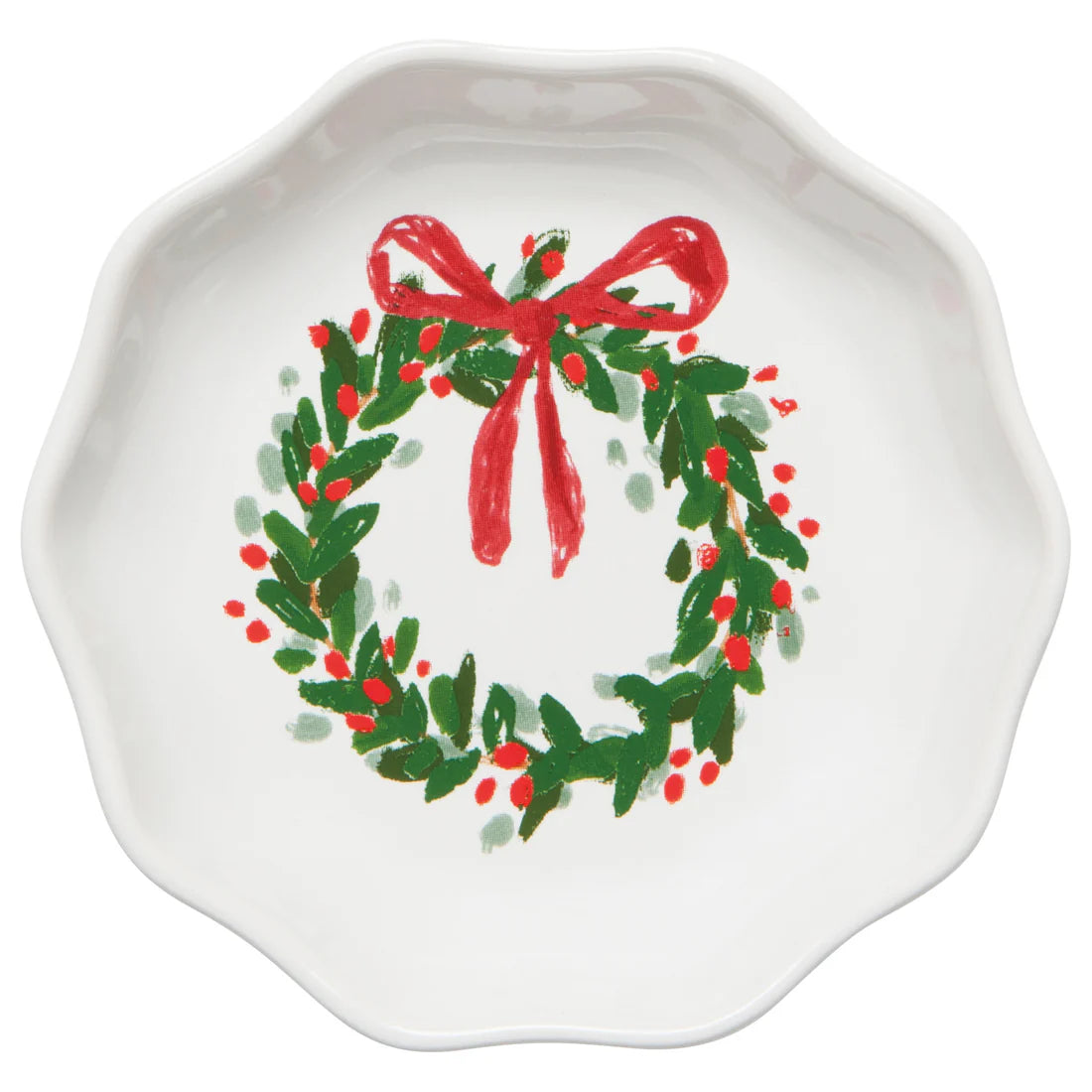 White dish with wreath printed in the bottom of it, wreath has red berries and red bow on top.