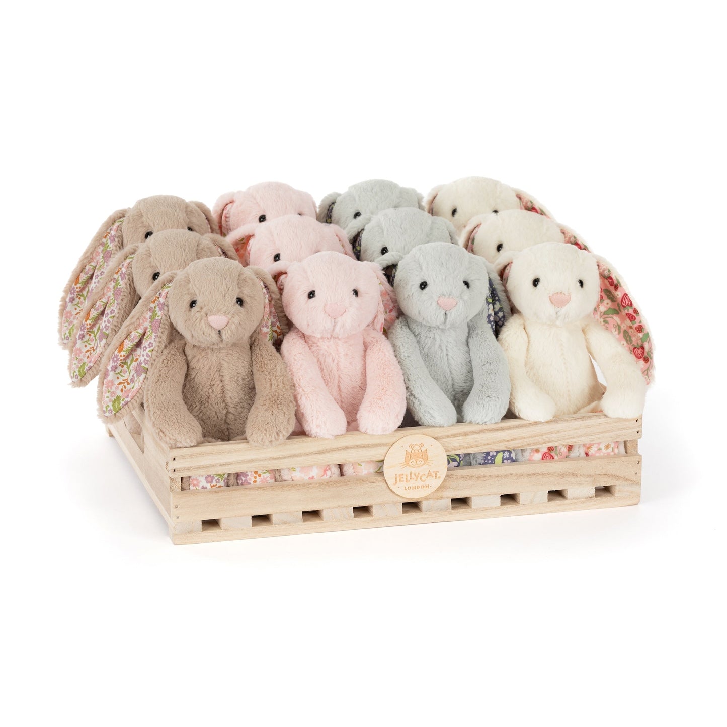 fluffle of assorted colors of bunnies in a wooden crate.