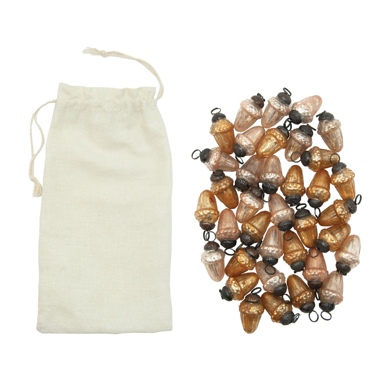 acorn shaped mercury glass ornaments in a pile next to their muslin bag