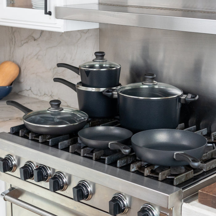 Classic Plus 10 Piece Setarranged on a gas stove top in a modern kitchen setting