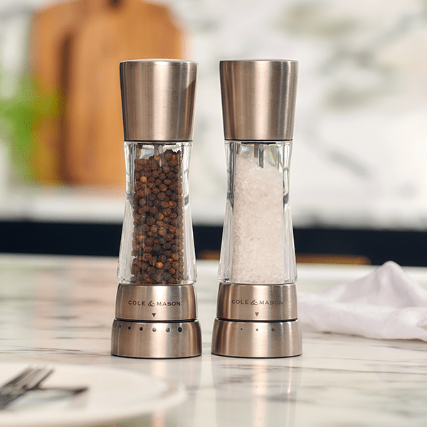 salt and pepper mills on a marble countertop.