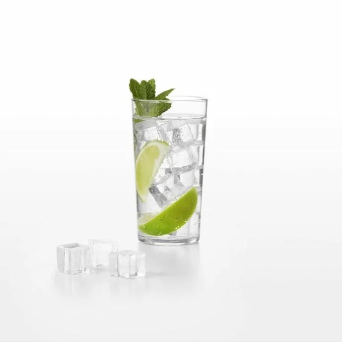 glass with square ice cubes in water with lime garnish and several square ice cubes set in front of the glass
