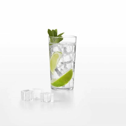 glass with square ice cubes in water with lime garnish and several square ice cubes set in front of the glass