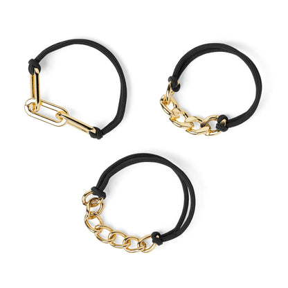 3 assorted black hair ties with gold tone chain accents on them.