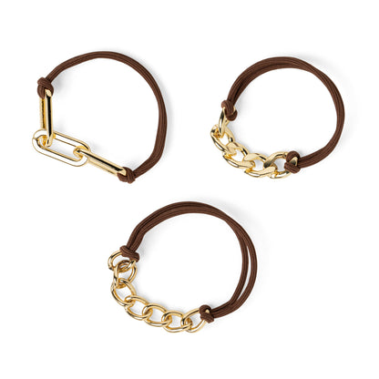 3 assorted brown hair ties with gold tone chain accents on them.
