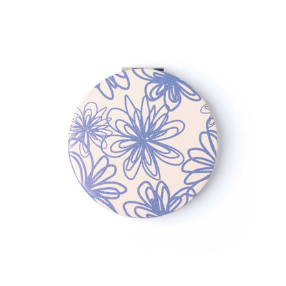 compact mirror with blue floral design.