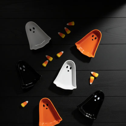 6 pinch bowls in the shape of ghosts in black, orange, or white all with a happy facial expression.