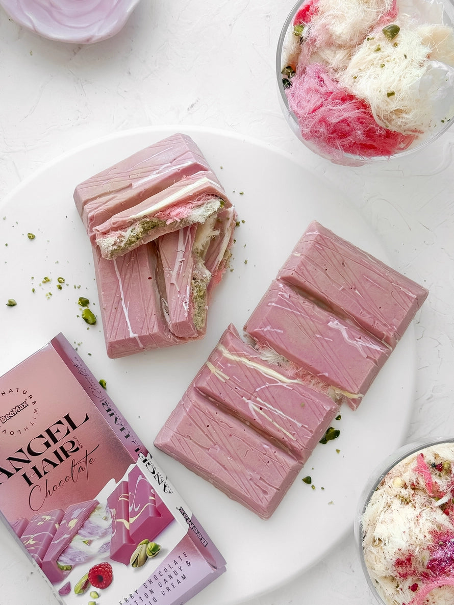 pink angel hair chocolate bars arranged on a plate with another bar in its packaging.
