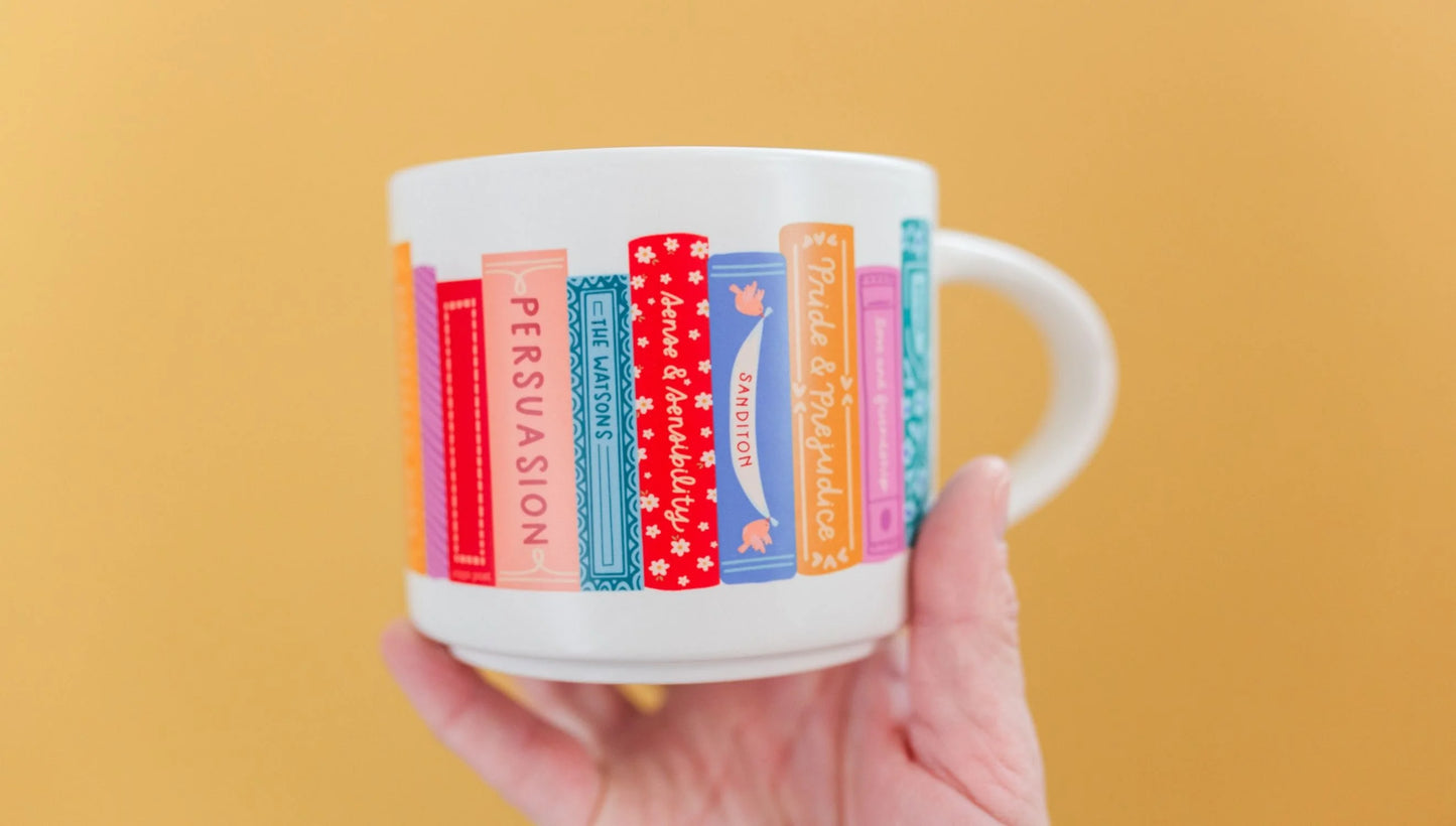 hand holding mug showing opposite side of Jane Austen Books Ceramic Mug in front of a yellow background
