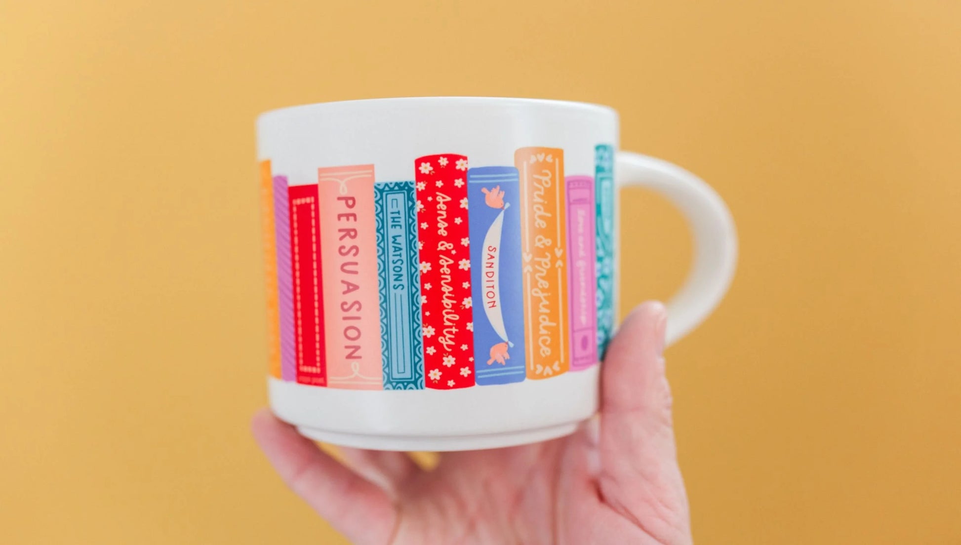 hand holding mug showing opposite side of Jane Austen Books Ceramic Mug in front of a yellow background