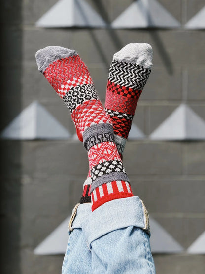 person wearing Mercury Crew Socks with their feet up in the air in front of a grey brick wall