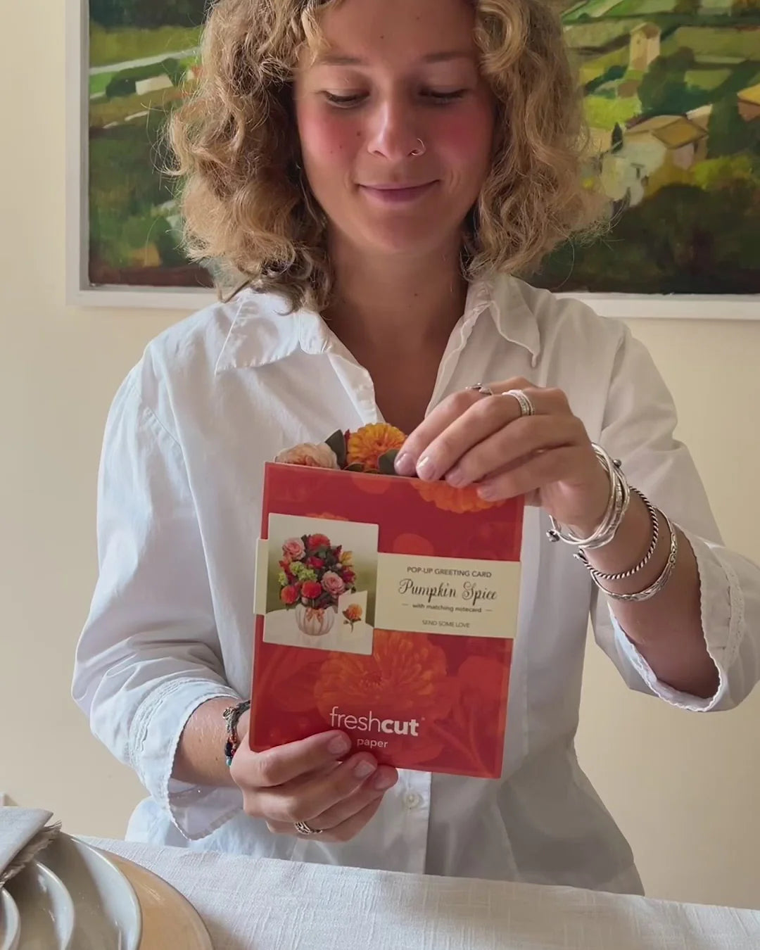 person taking pumpkin spice Pop-Up Greeting Card out of envelope.