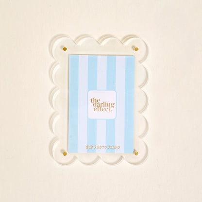 Scalloped clear magnetic frame against a white background.
