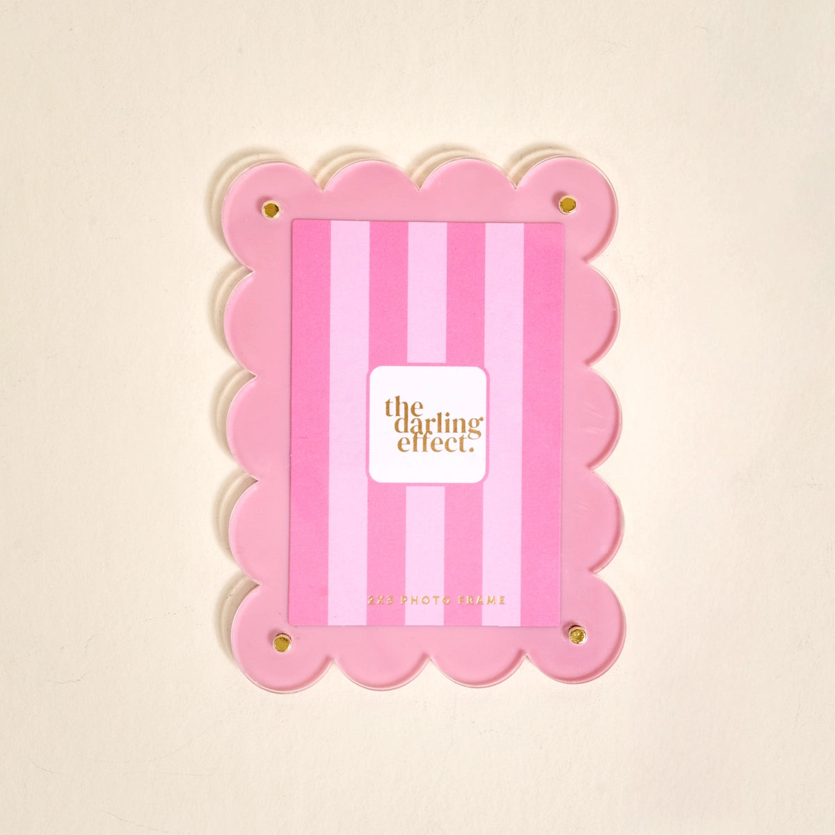 Scalloped pink magnetic frame on a white background.