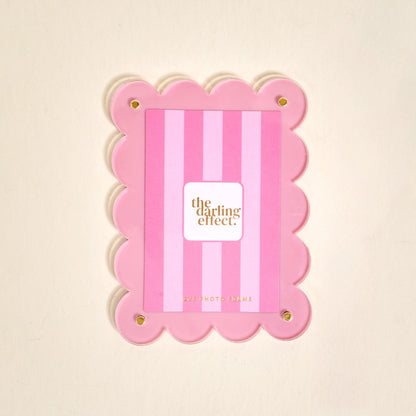 Scalloped pink magnetic frame on a white background.