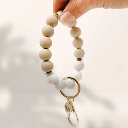 person holding oatmilk latte Hands-Free Keychain Wristlet