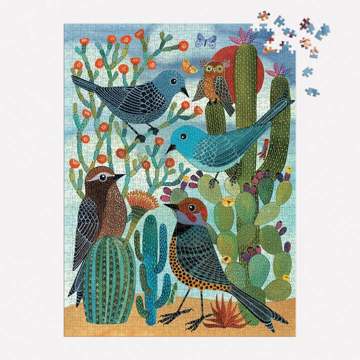 mostly finished Jigsaw puzzle with birds and cacti design shown with a few of the top corner pieces scattered on a white background
