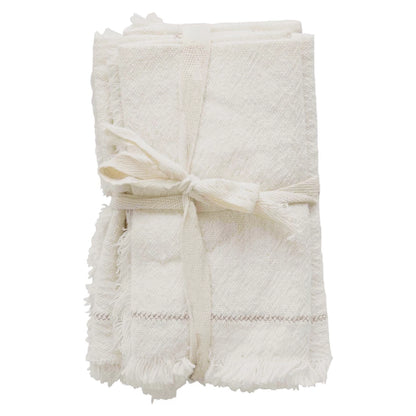 set of 4 white cloth napkins tied together with ribbon.