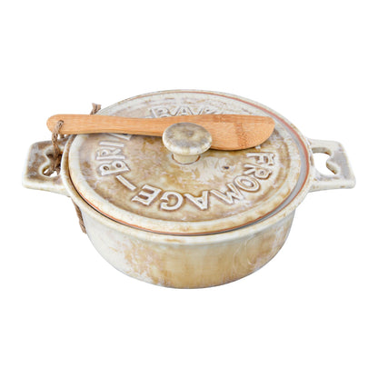 Ceramic baker with wooden knife on a white background