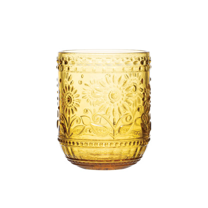 amber drinking glass with floral design on a white background.
